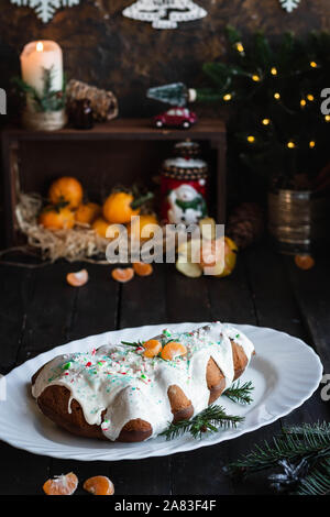 Chocolate-tangerine cupcake in the shape of a Christmas tree. Cupcake with icing and caramel topping. Holiday baking. Dessert on the New Year's table. Stock Photo