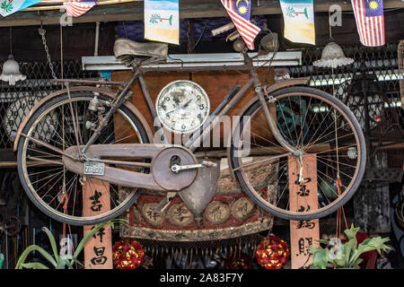 PENANG, MALAYSIA, NOV 12 2017, An old retro bicycle hangs on a wall. Bike mounted on the ceiling of shop, George Town, Penang. Stock Photo