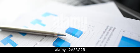 A silver pen lies on documents with Stock Photo