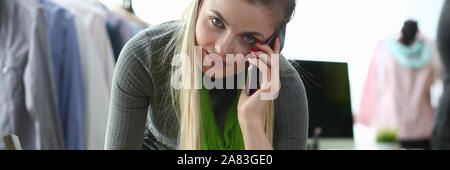 Clothes Design and Retail Designer Talking Phone Stock Photo