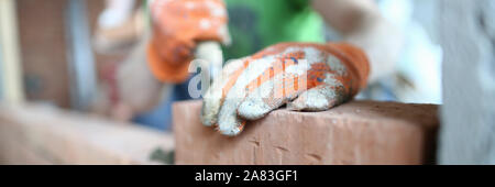 Male hands putting bricks Stock Photo