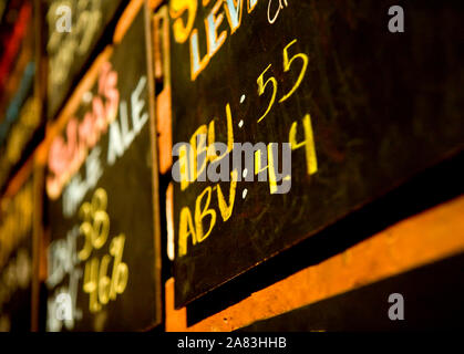 Close up of Chalkboard sign in restaurant with IBU and ABV information for beers. Stock Photo