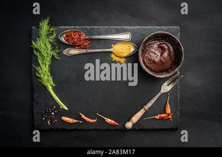 Black slate board with spices Stock Photo
