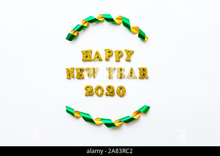 Simple happy new years 2020 text in gold lettering and curled ribbon isolated on white background - celebration and holidays concept image with copy s Stock Photo