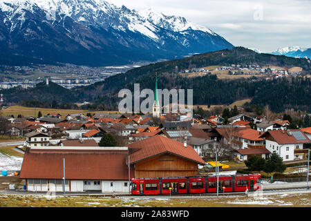 The Stubai Valley Railway Stubaitalbahn, a interurban tram from Innsbruck to Fulpmes, arriving at Mutters Pfarrkirche Pfarr church Innsbruck, Tirol, A Stock Photo