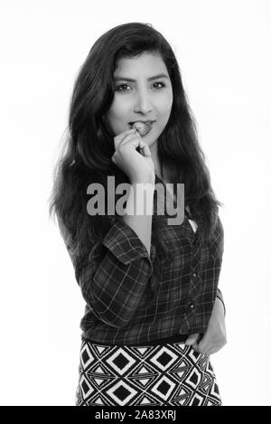 Studio shot of young beautiful Persian woman eating strawberry Stock Photo