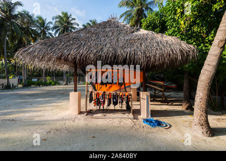 Huraa, Maldives - November 19, 2017: Water sports equipment under thatched roof on the island of Huraa, Maldives. Stock Photo