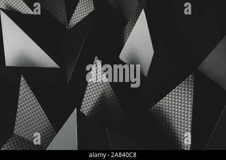Triangular shapes of paper on dark background, abstract Stock Photo