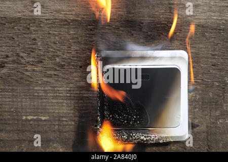 switch close-up. The fire was caused by a short circuit. Electric short curcuit. the fire is real Stock Photo