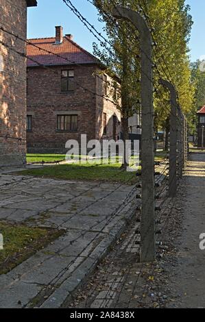 Buildings and barb wire fence in Auschwitz memorial museum Stock Photo