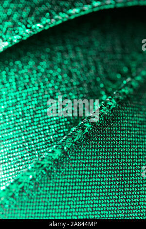 Abstract texture background of macro photographed shimmering green holiday fabric ribbon Stock Photo