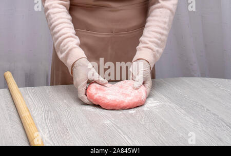 Preparing color dough for pelmeni, ravioli. Mom's hands Stock Photo