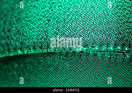 Abstract texture background of macro photographed shimmering green holiday fabric ribbon Stock Photo