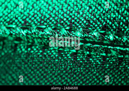 Abstract texture background of macro photographed shimmering green holiday fabric ribbon Stock Photo
