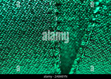 Abstract texture background of macro photographed shimmering green holiday fabric ribbon Stock Photo