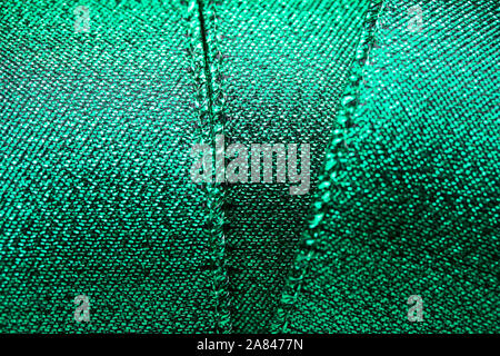 Abstract texture background of macro photographed shimmering green holiday fabric ribbon Stock Photo