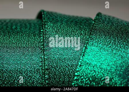 Abstract texture background of macro photographed shimmering green holiday fabric ribbon Stock Photo