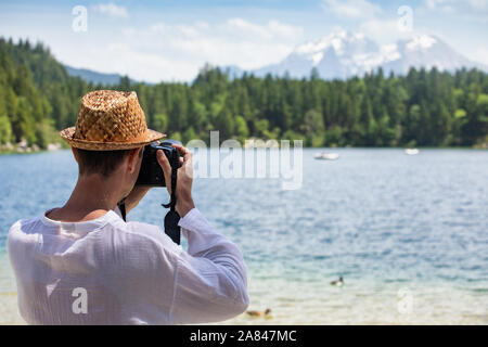 Man taking picture during journey in Alps Stock Photo