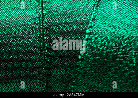 Abstract texture background of macro photographed shimmering green holiday fabric ribbon Stock Photo