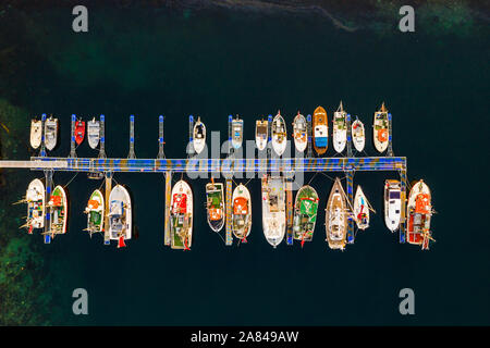 An assortment of boats docked near Husøy in Senja, Norway Stock Photo