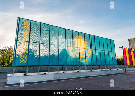 Nur-Sultan Astana National Flag of Kazakhstan Spanning over the Soil at Independence Square on a Sunny Cloudy Blue Sky Day Stock Photo