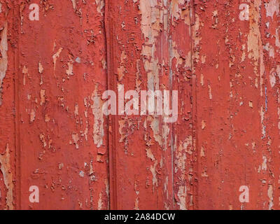 Background of old wooden fence with shelled red paint Stock Photo