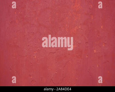 Detail of old red painted wall stucco covering, close-up Stock Photo