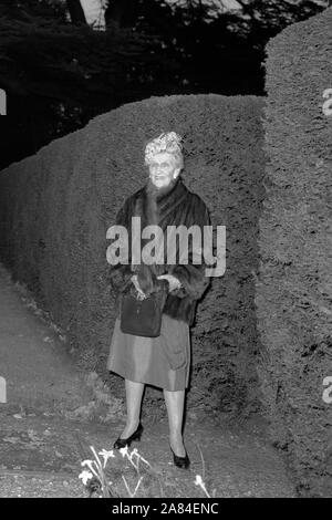 Nancy Astor, Viscountess Astor, in the gardens of Cliveden, her family home near Tallow, Buckinghamshire, where she attended the reception after her eldest son's third marriage. Earlier Viscount Astor, 53-year-old former Tory MP, was married in Hampstead, London, to model Bronwen Pugh. Stock Photo