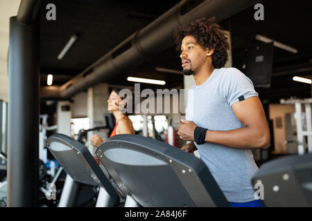 Fit group of people exercising on a treadmill in gym Stock Photo