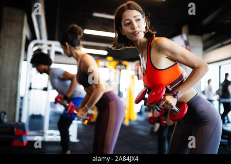 Beautiful fit women working out in gym Stock Photo