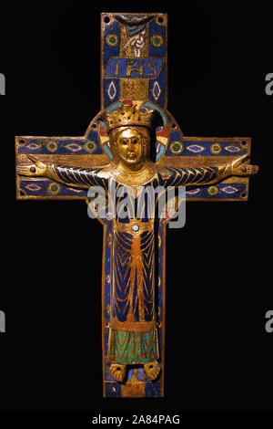 A copper champleve crucifix plaque, partially gilded and enamelled, executed circa 1200-1215 in Limoges, France, depicting Christ the King triumphant on the cross, on display at the Cluny Museum in Paris, France Stock Photo
