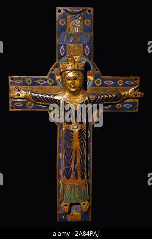 A copper champleve crucifix plaque, partially gilded and enamelled, executed circa 1200-1215 in Limoges, France, depicting Christ the King triumphant on the cross, on display at the Cluny Museum in Paris, France Stock Photo