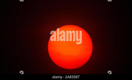 Red sun sphere in thick smog Stock Photo