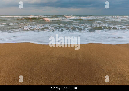 Stormy sunset on the sea coast Stock Photo