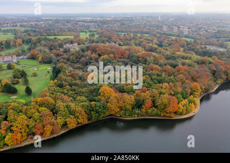 Aerial photo in autumn showing the beautiful autumn fall colours of a park in Leeds known as Roundhay Park in West Yorkshire UK, showing a typical Bri Stock Photo
