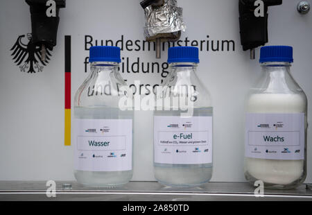 Eggenstein Leopoldshafen, Germany. 06th Nov, 2019. Bottles containing water, e-fuel and synthetic wax are located on the northern campus of the Karlsruhe Institute of Technology (KIT) in a research facility that can produce CO2-neutral fuel from air and green electricity using 'Power-to-X' technologies (P2X). The plant was officially put into operation. Credit: Marijan Murat/dpa/Alamy Live News Stock Photo
