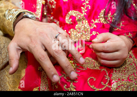 Groom places the wedding ring on the Bride’s finger at Bangladesh. Close up image. Stock Photo