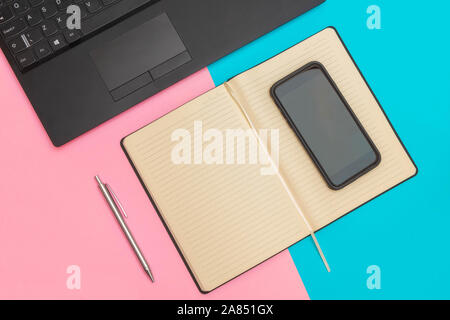 Flat lay of workspace with laptop, notebook, smartphone and pen Stock Photo