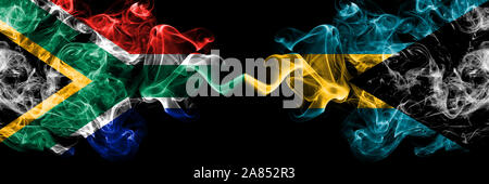 South Africa vs Bahamas, Bahamian smoky mystic flags placed side by side. Thick colored silky abstract smoke flags concept Stock Photo
