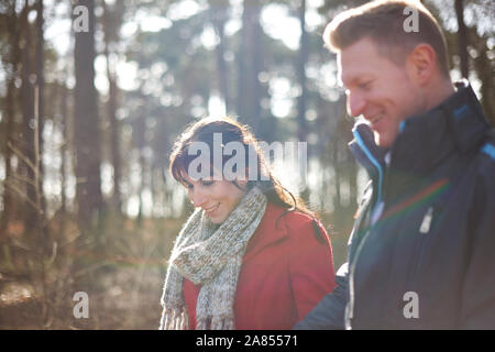 Couple hiking in sunny, autumn woods Stock Photo