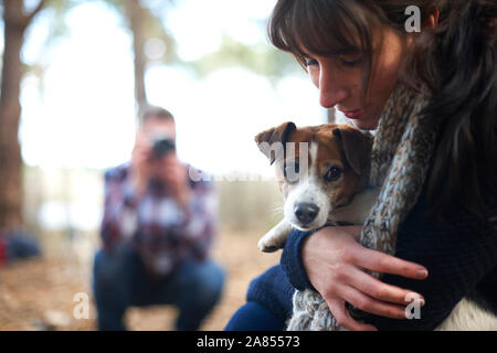 Woman hugging cute puppy dog Stock Photo