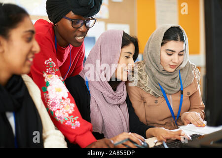 Female college students in hijab and dhuku using computer in computer lab Stock Photo