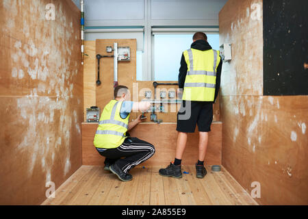 Male electrician students practicing in workshop Stock Photo