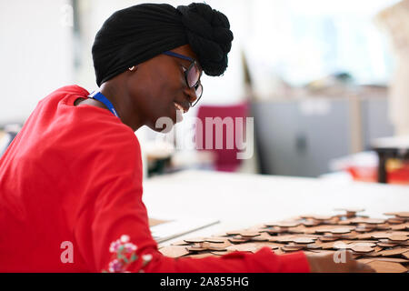 Young female artist wearing dhuku in art studio Stock Photo