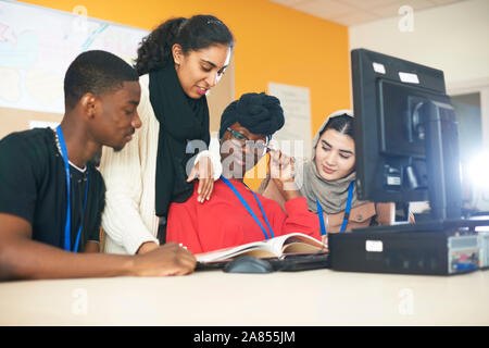 Multi-ethnic college students studying at computer in computer lab Stock Photo