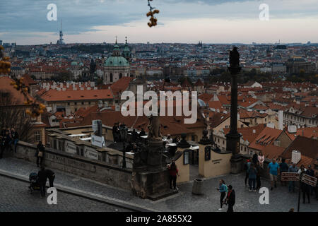 Prague, Czech Republic - October 27, 2019: Starbucks rooftop view from above Castle during twilight evening dusk with city lights starting to light up Stock Photo