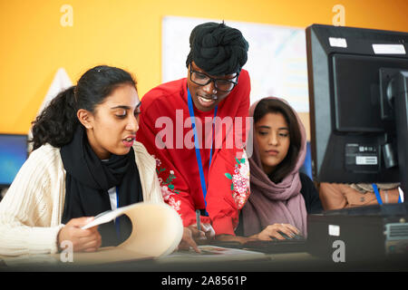 Female multi-ethnic college students using computer in computer lab Stock Photo