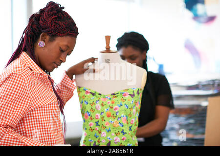 Female fashion designers using dressmakers model Stock Photo