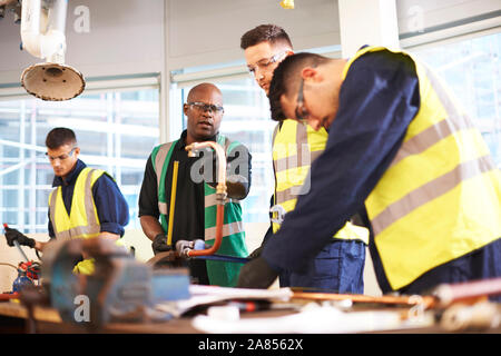 Male instructor and students in shop class workshop Stock Photo
