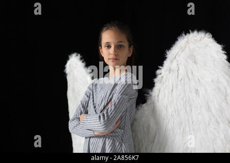 Portrait confident, brave girl wearing angel wings Stock Photo